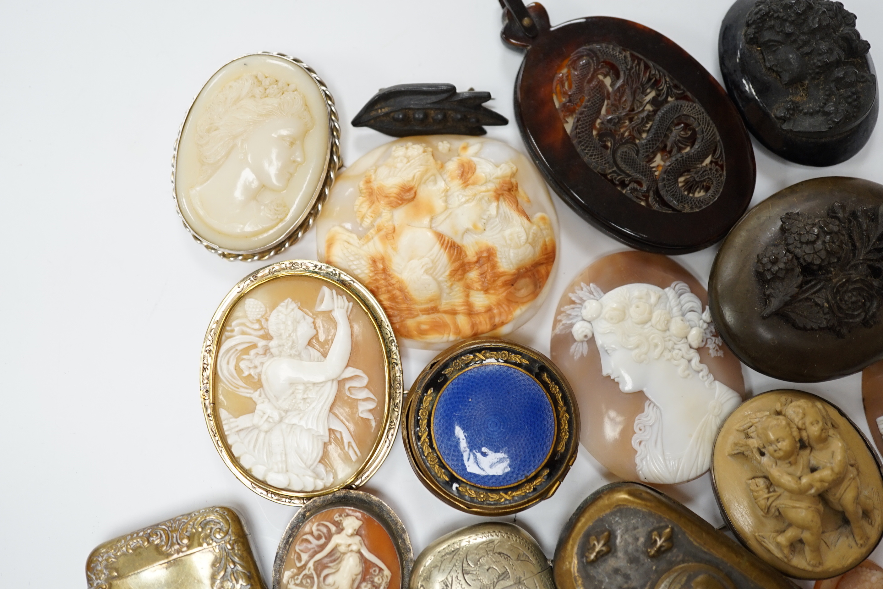 Five assorted unmounted carved cameo shells, largest 57mm, four other mounted cameo brooches including three shell, two base metal vestas and a box and sundry other items.